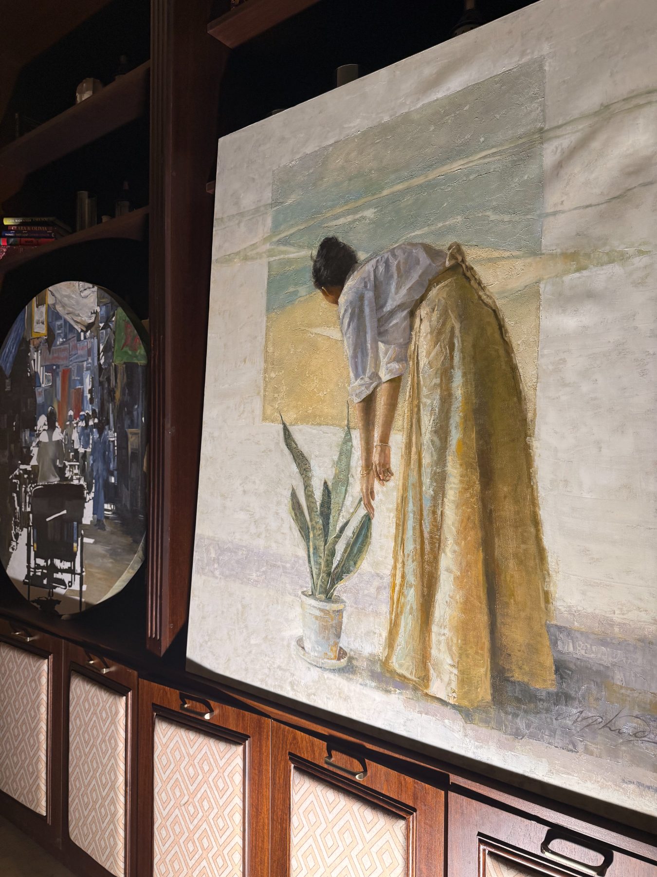 Woman with a plant, beside the round rickshaw canvas