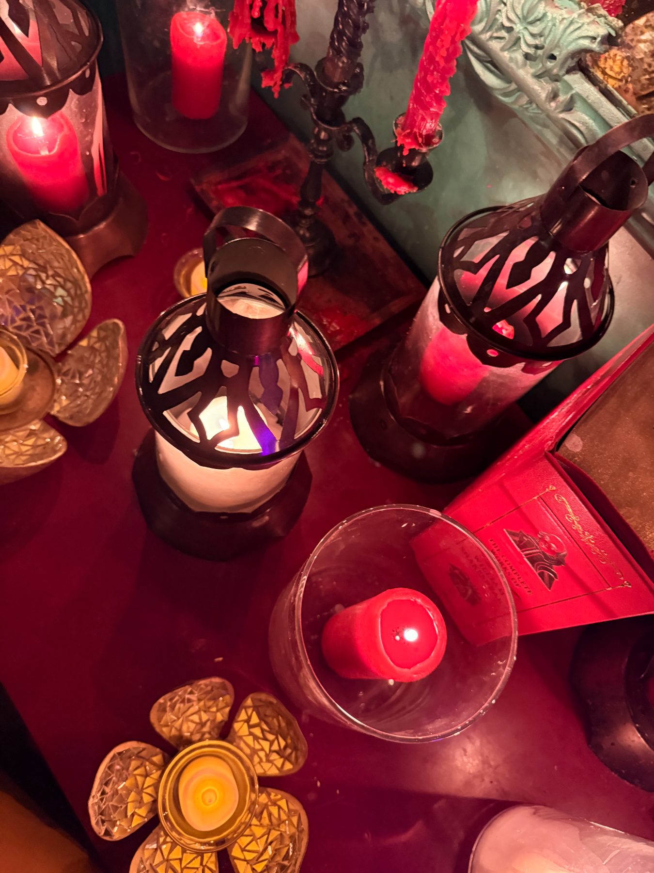 Red candles and lanterns on velvet