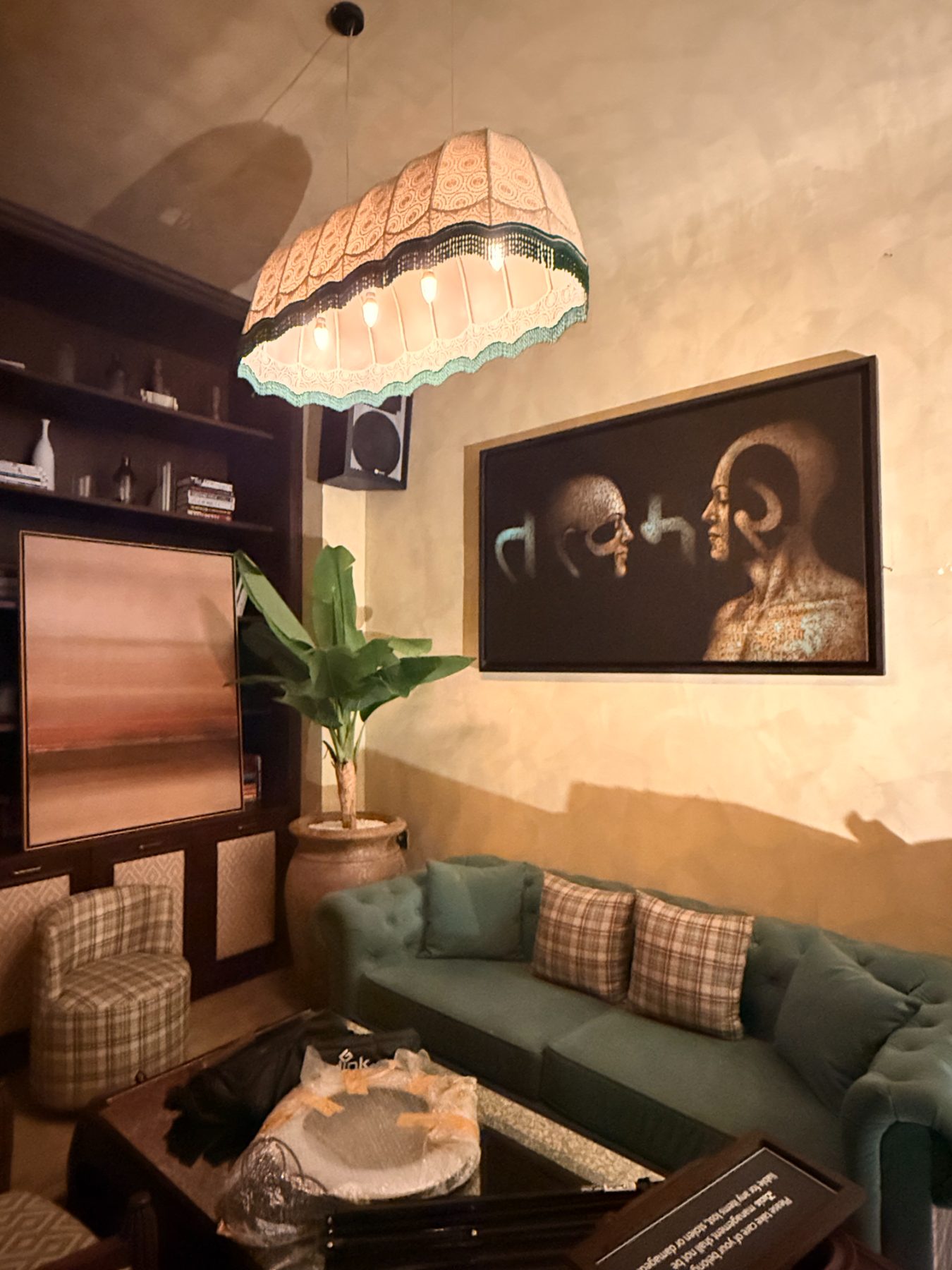 Golden heads under a fringed lamp