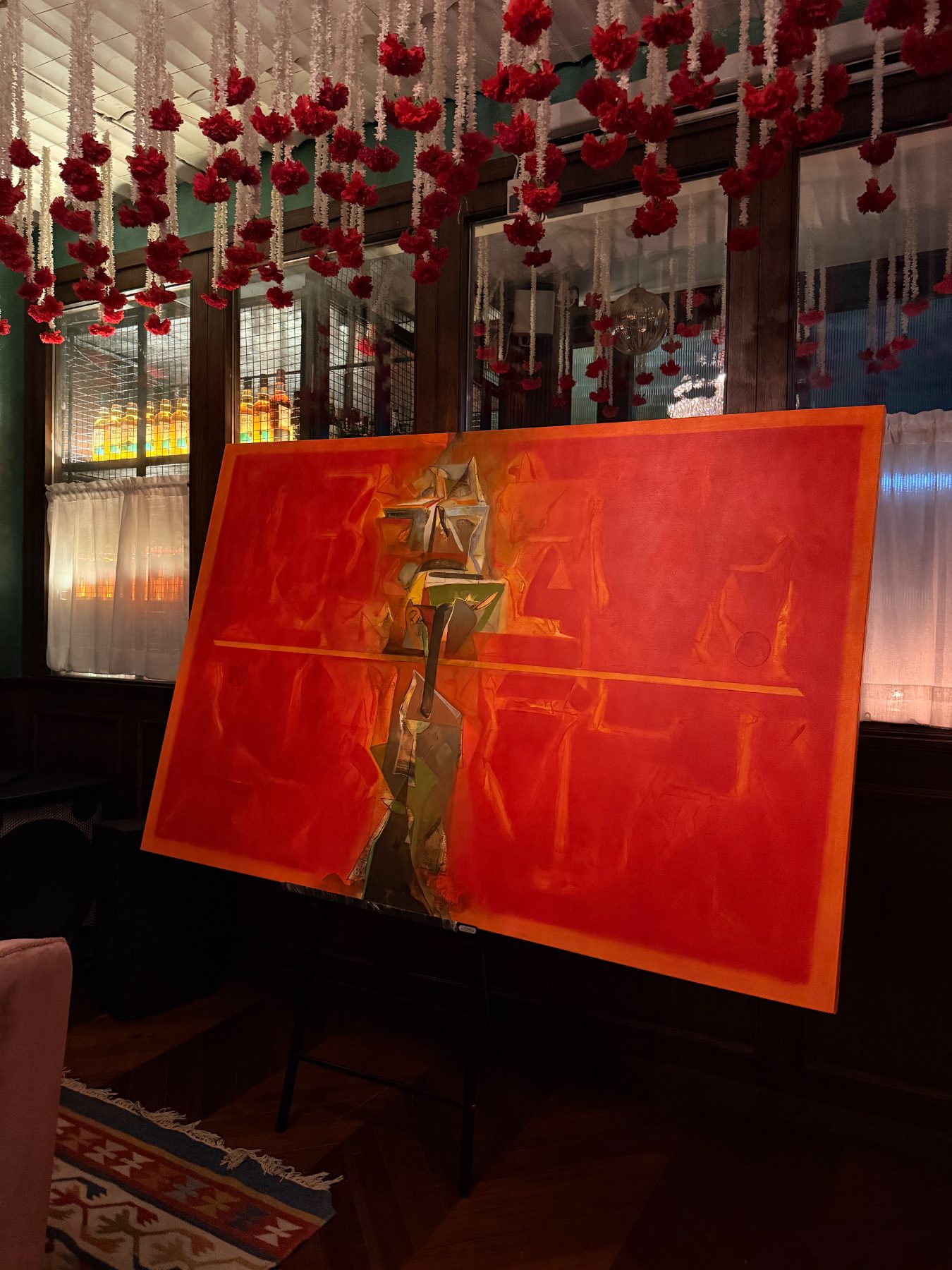 Carnation garlands above the red canvas